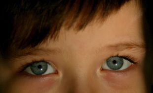 enlarged portrait of a child with blue eyes