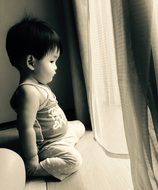 child on the windowsill, black and white