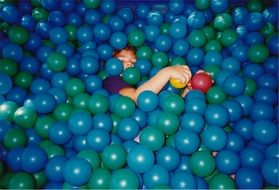 child playing in balls