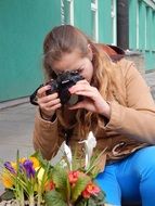 girl taking pictures of flowers