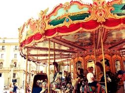 Children ride on a vintage carousel