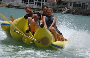 people on a banana as a boat