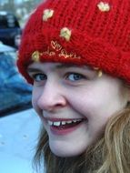 portrait of a smiling girl in a red hat