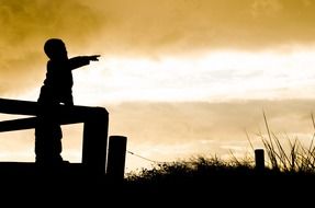 Silhouette of the child under the sunset