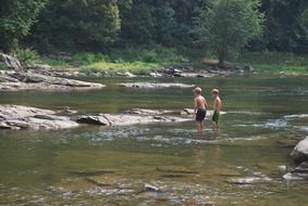 two boys play in the water on a summer day