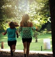 young girls run in the park