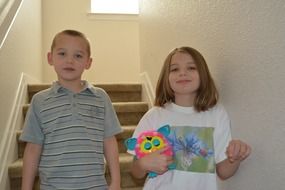 siblings girl boy standing on stairs