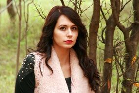 portrait of a girl brunette on a background of trees