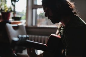 man playing guitar indoors