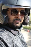 motorcycle rider in helmet and glasses on a motorcycle