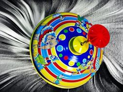 Colored spinning top on a gray background