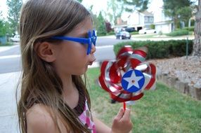 pinwheel toy girl blow red white