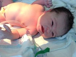 newborn baby lying on a blanket