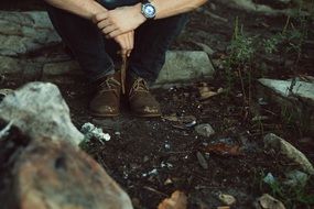 men sitting in the forest