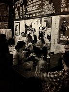 black and white photo of people in the tavern