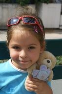 little smiling girl with soft toy