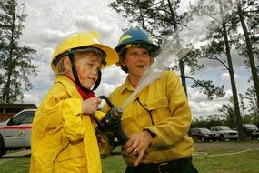 boys hold a water hose