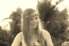 Black and white image of a beautiful girl who plays the guitar