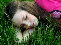 girl is sleeping on the grass