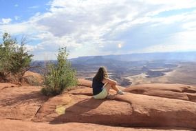 woman on a rock on a sunny day