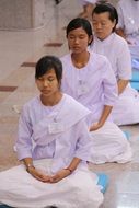 meditating asian buddhists women in row