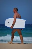 surfer with a whiteboard on the ocean