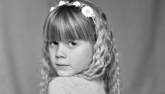 black and white photo of a girl with curly hair