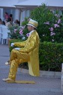 street performer in golden costume