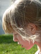 girl in the wind in profile on a sunny day