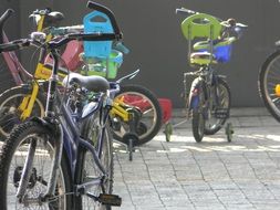 children's bicycles on the pavement on a sunny day