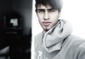 photo of a young man in a gray sweatshirt