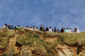 a crowd of tourists on top of a hill