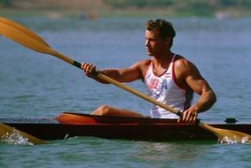 sportsman with a paddle on a kayak