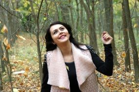 Happy girl walking in autumn park