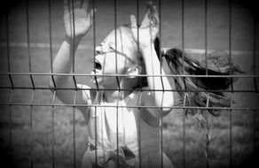 The girl screams behind bars