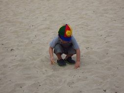 baby playing on the sandy beach