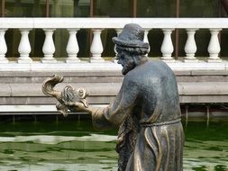 sculpture of an old man and a goldfish in Russia