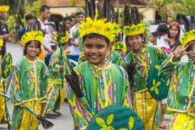 children in green yellow suits at street festival