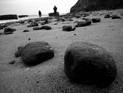 beach with large stones in black and white background