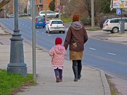 child and mother are on the road