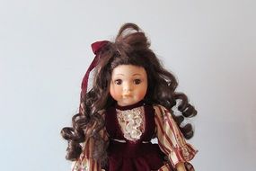 photo of a doll with brown curly hair