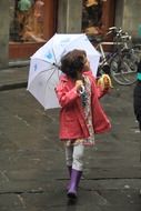 little girl in the rain with an umbrella