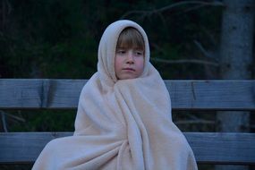 child in a blanket evening freeze