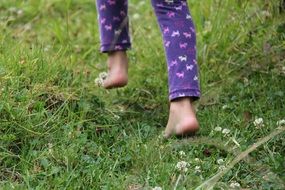 legs of a child on grass