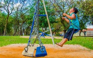 child boy swinging at playground