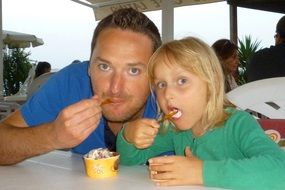 father and daughter eating ice cream
