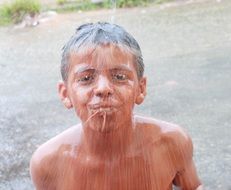 Child's face in a stream of clay