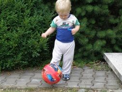 fair-haired child with a colorful ball