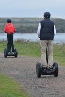 people on the electric scooters on the road
