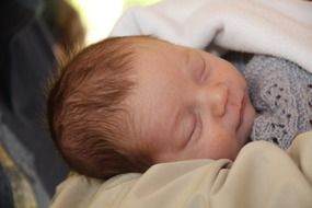 newborn baby sleeps on a blanket